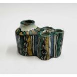 A Moroccan pottery inkwell, 19th century, decorated with polychrome geometric motifs, height 7cm,