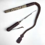 An Iraqi steel camel goad, early-mid 20th century, with leather grip, the wooden case applied with