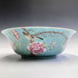 A Chinese porcelain bowl, early 20th century, with stylised pomegranates, the exterior with