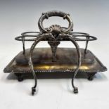 A George III silver five section swing handled cruet stand, the leaf and shell cast handle (