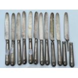 A George IV set of twelve shell and thread pattern dessert knives, with filled handles and silver