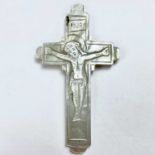 A carved mother of pearl double sided crucifix, one side with Corpus Christi, the other with