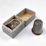 A George V silver thimble by Charles Horner, Chester 1911, together with another silver thimble,