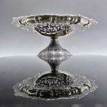 A good Victorian silver pedestal dish, with pie crust leaf scroll cast rim and with foliate scroll