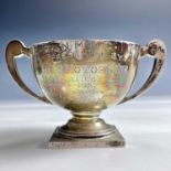 A George V silver twin handle pedestal trophy cup with engraved dedication, maker BM Co,