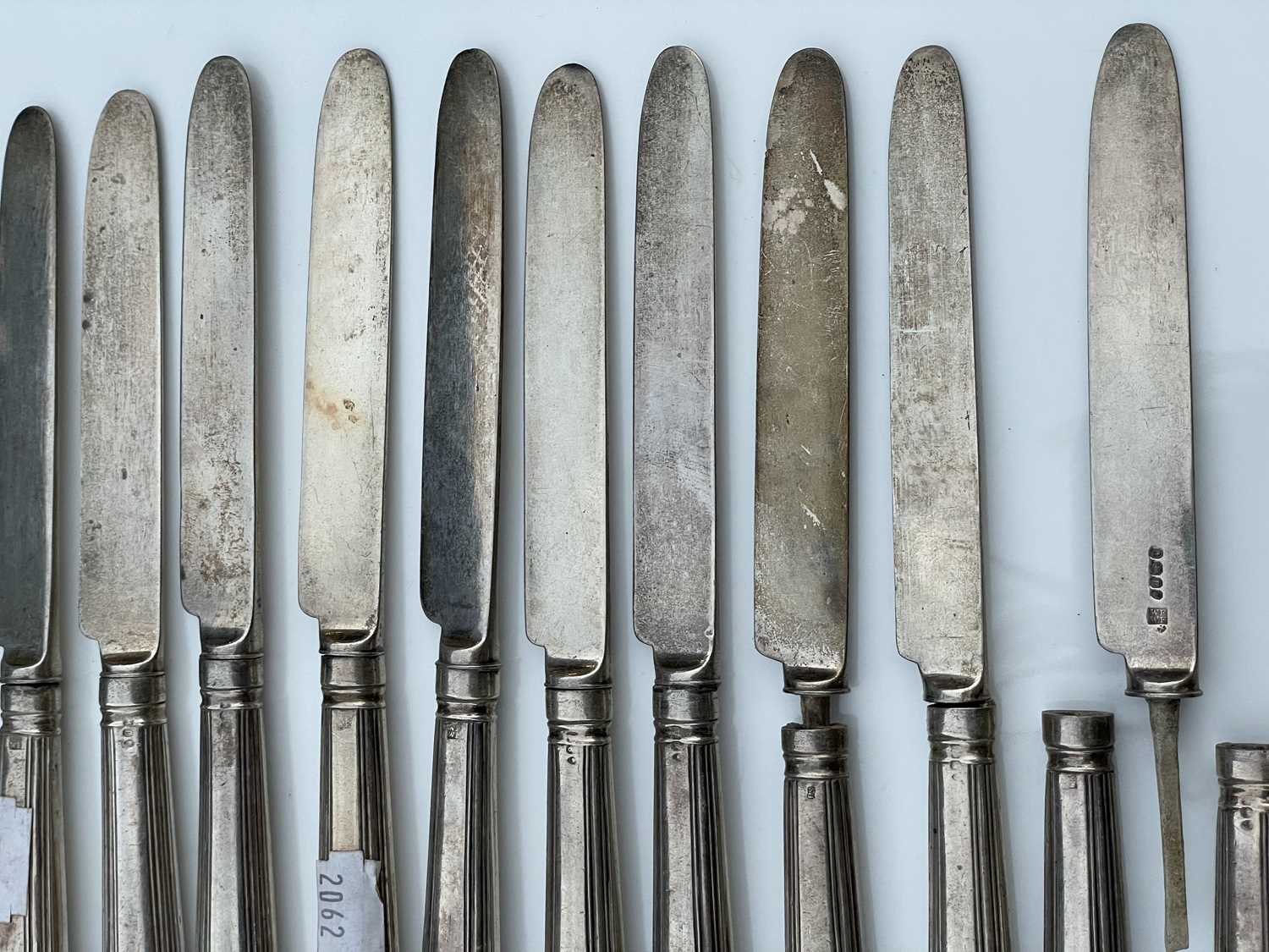 A George IV set of twelve shell and thread pattern dessert knives, with filled handles and silver - Image 3 of 8