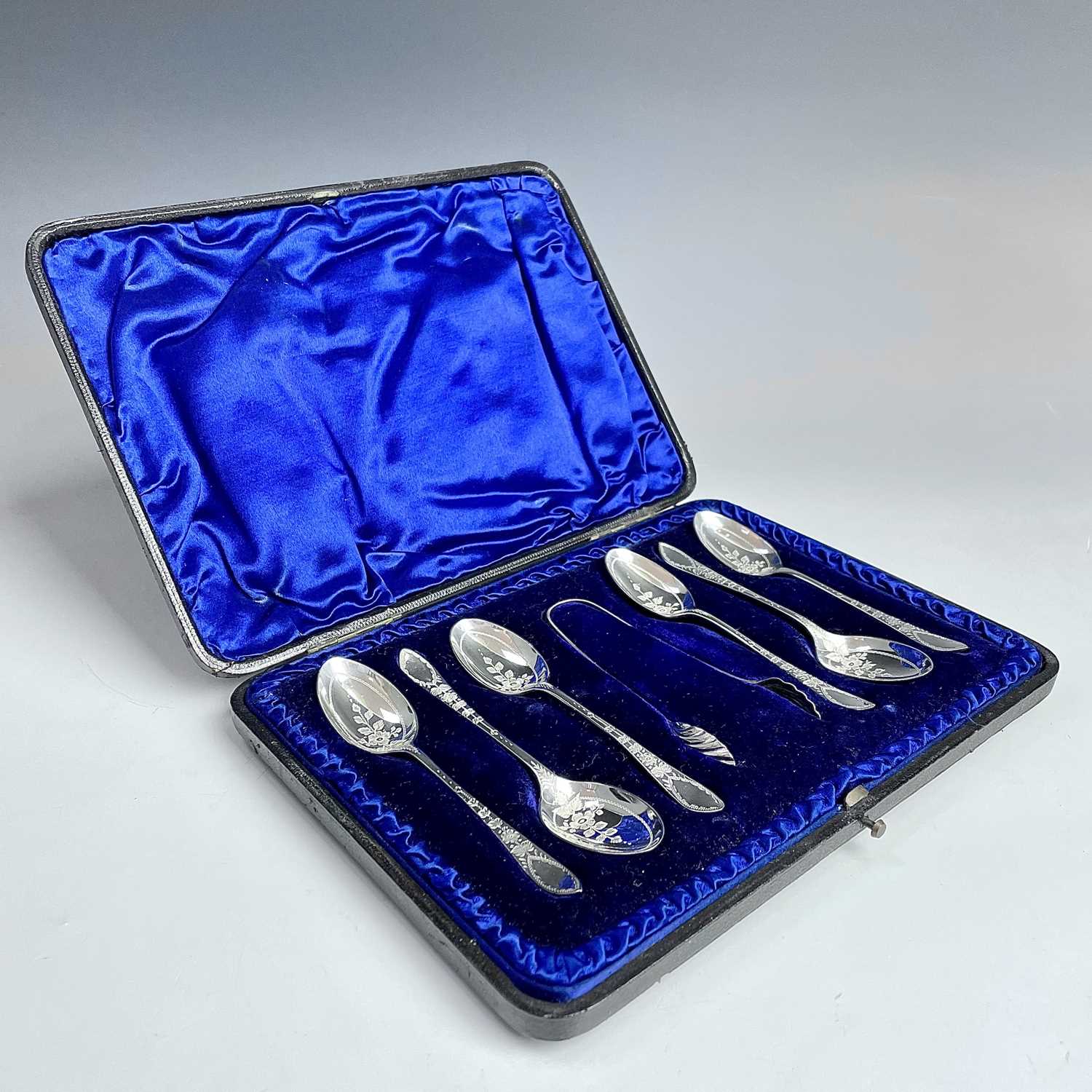 A Victorian cased set of six silver teaspoons and tongs with floral chased decoration by Atkins