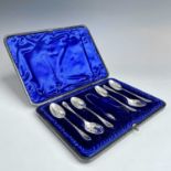 A Victorian cased set of six silver teaspoons and tongs with floral chased decoration by Atkins