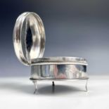 A George V silver circular engine turned hinge lidded trinket box raised on triple feet, maker S.B &