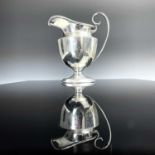 A George VI silver pedestal milk jug, makers mark rubbed, Birmingham 1946, height 10cm, weight 2.4