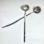 Two Georgian silver toddy ladles with twisted baleen handles, set with a Queen Anne sixpence and a
