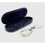 A pair of early 20th century 9ct gold mounted (tested) pinch spectacles within a 19th century papier