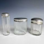 Three glass toilet jars with silver lids, weight of silver 1.67 toz.