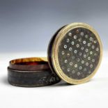 A 18th century French gold mounted mother of pearl dot inlaid circular section snuff box, diameter