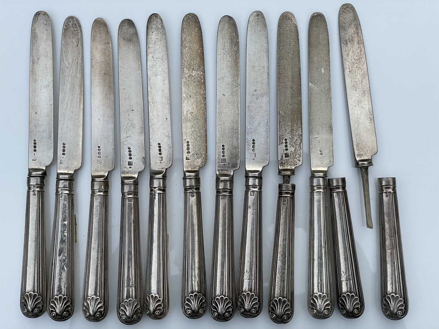 A George IV set of twelve shell and thread pattern dessert knives, with filled handles and silver - Image 7 of 8