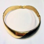 An Alexis Kirk gilt metal and black enamel hinged choker.Condition report: Some minor scratches to