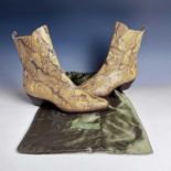 A pair of snake skin leather boots, size 6.5, within a Valentino Garavani bag.