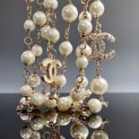 A Chanel rose gold plated, white enamel and paste set long necklace with cultured pearls, original