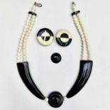 A stylish 1960's black and white celluloid necklace and matching clip earrings, length of necklace