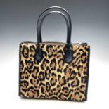 Michael Kors, a pony fur and leather leopard printed handbag, width 31.5cm.