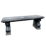A reconstituted stone bench of neoclassical design with volute scroll ends, height 45cm width