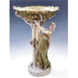A Royal Dux figural centrepiece, circa 1910, modelled as a lady picking apples from a tree, the