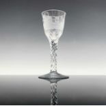 A Georgian wine glass, circa 1780, the ogee bowl engraved with buildings, including a turret and a