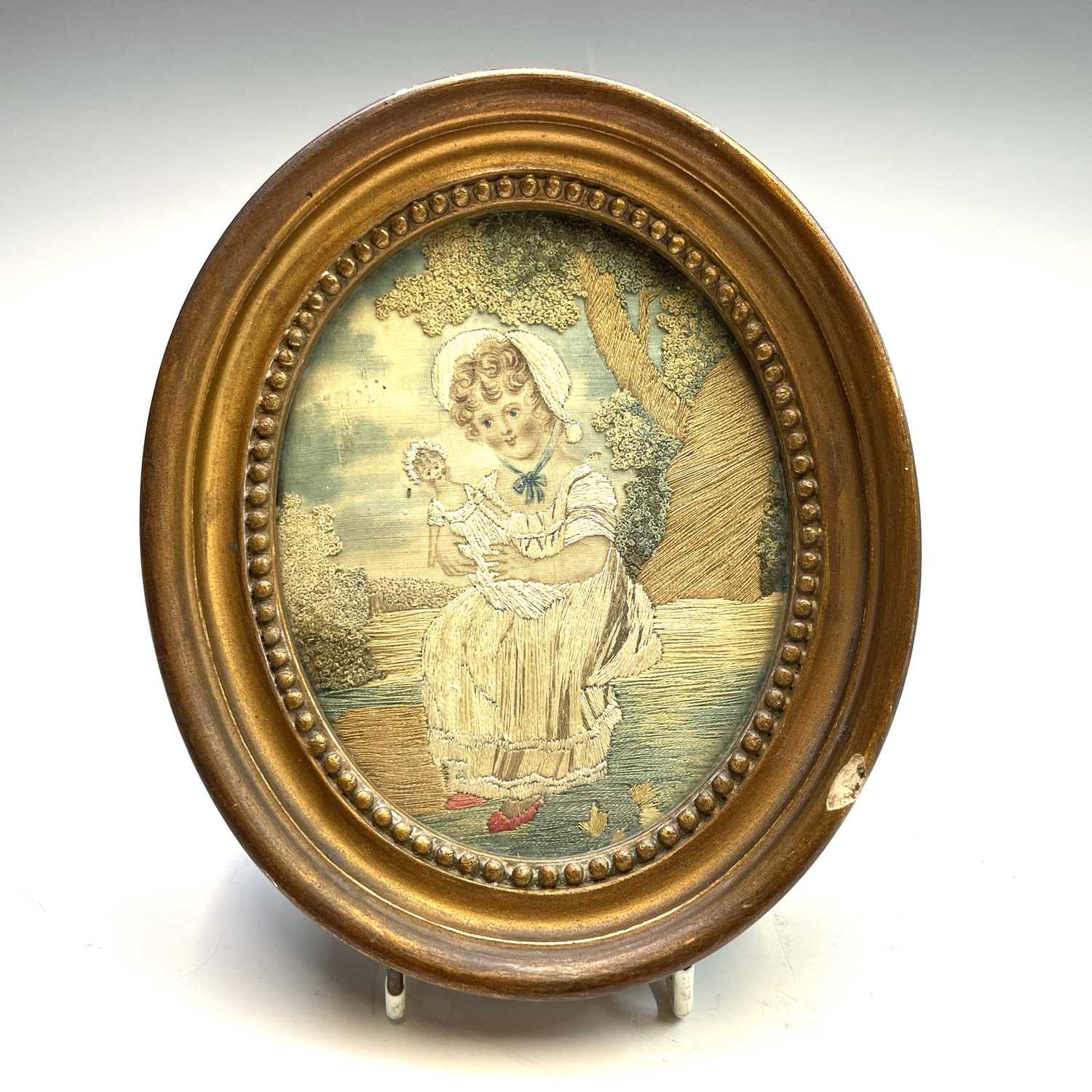 A pair of Regency small oval silk work pictures, with a boy picking fruit and a girl with a doll, - Image 5 of 17