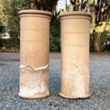 A pair of stoneware chimney pots, incised band decoration, height 78cm diameter 31cm.