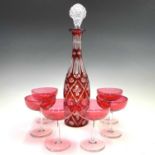 A ruby flash decanter and a stopper, height 38cm, together with a set of six cranberry glass