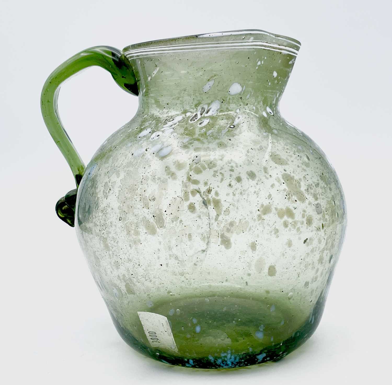 A Nailsea type glass jug, circa 1800, pale green with opaque white mottling, height 15cm.Provenance: - Image 5 of 5