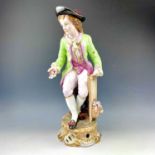 A large continental porcelain figure of a gallant with flowers on a rococo scroll base, height