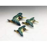 A set of three Beswick pottery graduated wall plaques modelled as kingfishers, printed and impressed