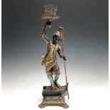 A Venetian blackamoor gondolier figure, circa 1900, with painted and gilt decoration, modelled