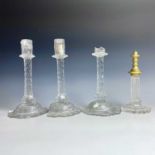 A suite of three Georgian cut glass candlesticks, with multi-facetted stems, height 28cm, together