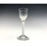 A George III wine glass the half-fluted ogee bowl on an opaque spiral twist stem, height 14.4cm,
