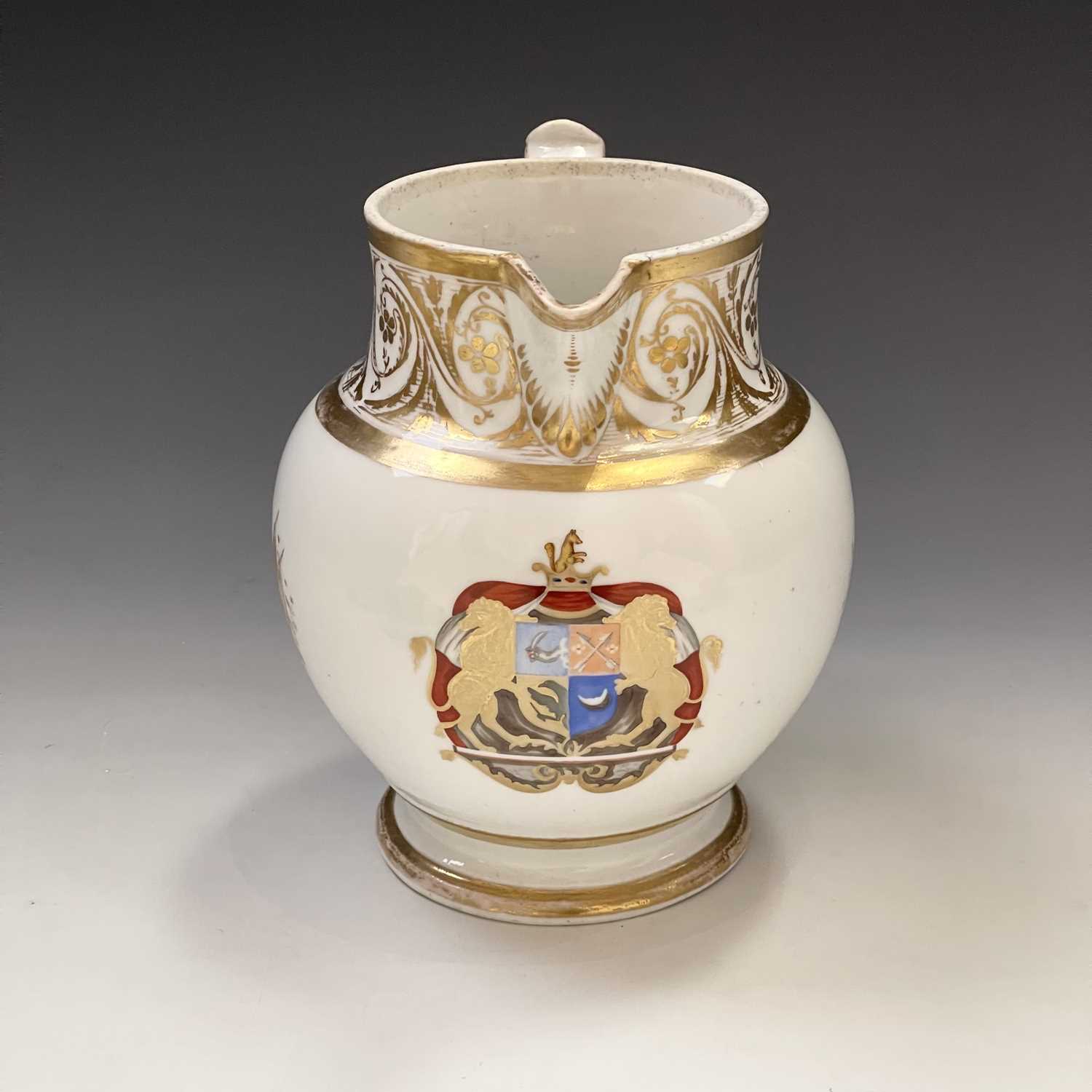 A 19th century porcelain armorial jug highlighted with finely gilt panels below a foliate scroll - Image 2 of 7