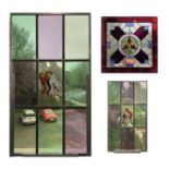 A square stained glass panel with a symmetrical design, 51cm, and a pair of stained glass panels the