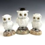 A Continental porcelain owl oil lamp base, circa 1890, with inset glass eyes on a mound base, height