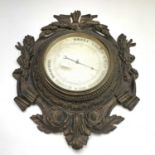 A Dutch aneroid barometer, late 19th century, the dial signed Cossa, in an ornate gilt decorated