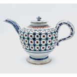 A Delft teapot and cover, circa 1770, decorated in polychrome with a geometric repeating design,