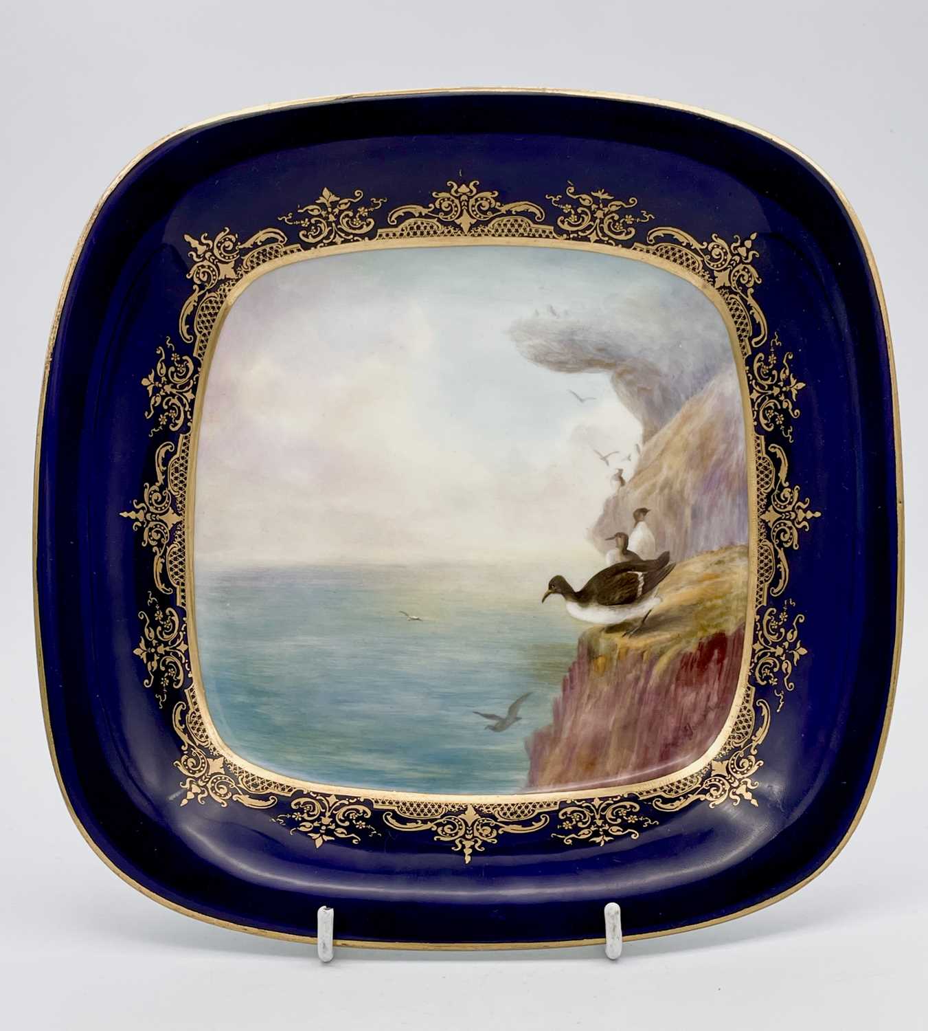 A Royal Worcester square dish, signed George Johnson, painted with and also inscribed 'Guillemot',
