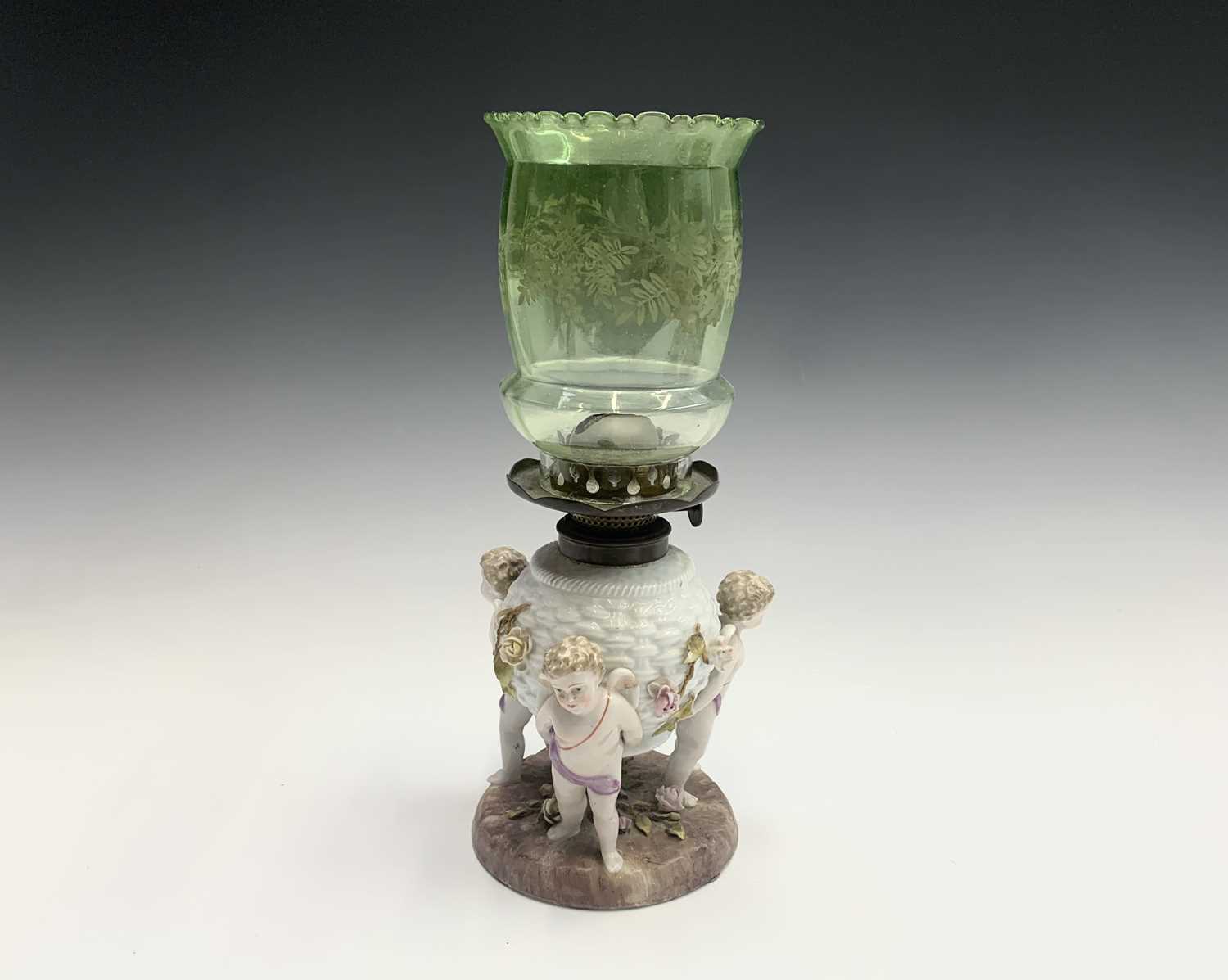 A German porcelain oil lamp base, circa 1900, modelled as a basket supported by three cherubs, - Image 2 of 10