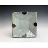 William MARSHALL (1923-2007) A stoneware square dish, tenmoku with drip glaze, potters mark to base,