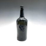 A late 18th century sealed wine bottle, circa 1790, the seal with a hand on a shield and