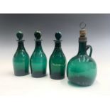 A set of three Regency green glass decanters and stoppers, labelled for Brandy, Rum and Hollands,