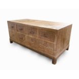 A Heal's Arts & Crafts limed oak low bedroom chest with an arrangment of five drawers, width