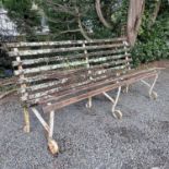 A wrought iron and slatted bench originally from Lord's cricket ground, length 184cm.