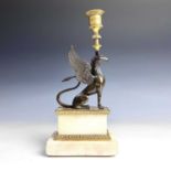 A French bronze and ormolu candlestick, late 19th century, modelled as a winged griffin, on a