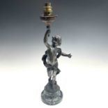 After Auguste Moreau, a bronzed lamp, modelled as a cherubic youth supporting the torch in his